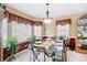 Elegant dining room with a glass table, decorative accents, and bright windows at 76 Riverbend Trl, Douglasville, GA 30134