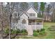 Home with a charming front porch and well-manicured landscaping at 76 Riverbend Trl, Douglasville, GA 30134