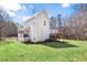 Exterior elevation with white siding, a deck, and a lush lawn at 76 Riverbend Trl, Douglasville, GA 30134