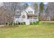 Charming two-story home with a covered front porch and well-maintained lawn, situated on a tree-lined lot at 76 Riverbend Trl, Douglasville, GA 30134