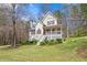 Charming two-story home with a covered front porch and well-maintained lawn, surrounded by trees at 76 Riverbend Trl, Douglasville, GA 30134