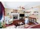 Inviting living room with a stone fireplace, hardwood floors, and an open view to the dining area at 76 Riverbend Trl, Douglasville, GA 30134