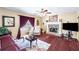 Comfortable living room featuring hardwood floors, a stone fireplace, and large windows for natural light at 76 Riverbend Trl, Douglasville, GA 30134