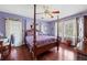 Serene main bedroom with hardwood floors, a four-poster bed, and lots of natural light at 76 Riverbend Trl, Douglasville, GA 30134