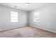 Bedroom featuring neutral carpet, light gray walls, and two windows at 900 Oakhill Sw Ave, Atlanta, GA 30310