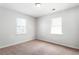 Bedroom featuring neutral carpet, light gray walls, and two windows at 900 Oakhill Sw Ave, Atlanta, GA 30310