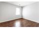 Bedroom featuring wood-look floor, light gray walls, and one window at 900 Oakhill Sw Ave, Atlanta, GA 30310