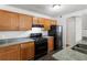 Kitchen features granite countertops, wood cabinets and black appliances at 900 Oakhill Sw Ave, Atlanta, GA 30310