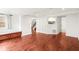 Finished basement with hardwood floors, white walls, ample storage, and direct access to stairs at 106 Maple St, Roswell, GA 30075