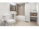 Modern bathroom featuring a pedestal sink, shower with tile surround, and a linen closet at 106 Maple St, Roswell, GA 30075