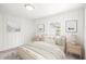 Serene bedroom featuring white walls, a cozy bed, and natural light, creating a tranquil retreat at 106 Maple St, Roswell, GA 30075