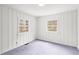 A bright bedroom with two double hung windows and white vertical paneling on the walls at 106 Maple St, Roswell, GA 30075