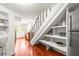 Bright kitchen boasts hardwood floors and convenient under-stair storage at 106 Maple St, Roswell, GA 30075
