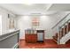Well-equipped kitchen area with a stainless steel sink, dishwasher, and staircase, offering functionality and style at 106 Maple St, Roswell, GA 30075