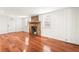 Bright living room featuring a stone fireplace and gleaming hardwood floors at 106 Maple St, Roswell, GA 30075