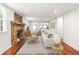 Cozy living room featuring a stone fireplace, hardwood floors, and a comfortable seating area at 106 Maple St, Roswell, GA 30075