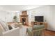 Inviting living room with stone fireplace, wood floors, and natural light, offering a warm ambiance at 106 Maple St, Roswell, GA 30075