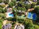 Aerial view of community amenities: a pool and tennis courts surrounded by lush trees and neighborhood homes at 237 Webney Se Dr, Marietta, GA 30068
