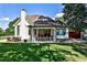 View of a well-manicured backyard with a covered patio, dining area, and a spacious lawn at 237 Webney Se Dr, Marietta, GA 30068