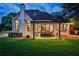 Backyard featuring a covered patio, outdoor dining space, and lush green lawn at 237 Webney Se Dr, Marietta, GA 30068