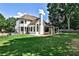 Expansive backyard featuring a well-maintained lawn and a charming white home with large windows at 237 Webney Se Dr, Marietta, GA 30068