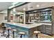 Finished basement bar area featuring seating, marble countertops, and a full bar at 237 Webney Se Dr, Marietta, GA 30068