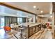 Finished basement boasts a custom bar with seating, wine fridge, and adjacent living area at 237 Webney Se Dr, Marietta, GA 30068