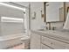 Well-lit bathroom featuring a bathtub with shower, and vanity with marble countertop at 237 Webney Se Dr, Marietta, GA 30068