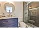 Updated bathroom with blue vanity, modern fixtures, marble countertops, and glass shower with tiled walls at 237 Webney Se Dr, Marietta, GA 30068