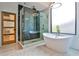 Beautiful bathroom featuring a modern tub, a glass-enclosed shower, marble floors, and a unique light fixture at 237 Webney Se Dr, Marietta, GA 30068
