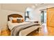 Bright bedroom featuring two beds, wood floors, and a barn door to the bathroom at 237 Webney Se Dr, Marietta, GA 30068