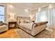 Bright bedroom featuring a luxurious crushed velvet bed, soft carpet, and floor to ceiling sheer window treatments at 237 Webney Se Dr, Marietta, GA 30068