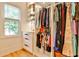 Well-organized closet with shelving, drawers, and hanging rods, illuminated by natural light from a nearby window at 237 Webney Se Dr, Marietta, GA 30068
