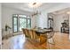 Elegant dining room with modern chandelier, hardwood floors, arched windows, and stylish seating for eight at 237 Webney Se Dr, Marietta, GA 30068