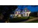 Night view of a stunning two-story home, with its exterior lighting accentuating the lush lawn and stately facade at 237 Webney Se Dr, Marietta, GA 30068