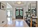 Bright foyer with wood floors, black framed glass doors, stylish console table, and elegant chandelier at 237 Webney Se Dr, Marietta, GA 30068