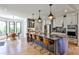 Spacious kitchen featuring a large island with seating, stainless steel appliances, and stylish pendant lighting at 237 Webney Se Dr, Marietta, GA 30068