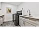 Well-lit laundry room with gray cabinets, modern hardware, and updated washer and dryer at 237 Webney Se Dr, Marietta, GA 30068
