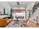 Stylish living room featuring modern decor, staircase, and open patio access at 237 Webney Se Dr, Marietta, GA 30068