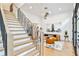 Open living room with hardwood floors, modern staircase, and airplane art at 237 Webney Se Dr, Marietta, GA 30068