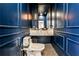 Sophisticated powder room with blue walls, marble countertop, and stylish fixtures at 237 Webney Se Dr, Marietta, GA 30068