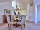 Open dining room with chandelier, seating for four, and adjacent to kitchen at 2730 Vintage Reserve Ln, Marietta, GA 30066