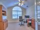 A quiet home office featuring natural light, vaulted ceilings, and functional decor at 2730 Vintage Reserve Ln, Marietta, GA 30066