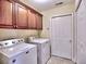 Bright laundry room with washer, dryer, overhead cabinets, and tiled flooring at 2730 Vintage Reserve Ln, Marietta, GA 30066