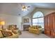 A cozy living room featuring a fireplace, vaulted ceiling, and abundant natural light at 2730 Vintage Reserve Ln, Marietta, GA 30066