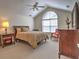 Spacious main bedroom featuring vaulted ceilings, a ceiling fan, and a large window at 2730 Vintage Reserve Ln, Marietta, GA 30066