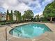 Community pool with lounge chairs, umbrellas, and manicured greenery surrounding the area at 2730 Vintage Reserve Ln, Marietta, GA 30066