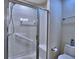 Bathroom shower with glass doors, tiled walls, grab bar, and built-in seat at 2730 Vintage Reserve Ln, Marietta, GA 30066