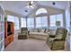 A bright sun room with large windows, vaulted ceiling, and comfortable seating at 2730 Vintage Reserve Ln, Marietta, GA 30066