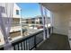 Balcony with dark wooden railing, white curtains, and views of nearby townhomes at 6569 Beacon Dr, Sandy Springs, GA 30328